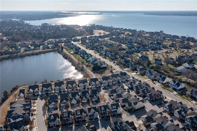 drone / aerial view with a water view and a residential view