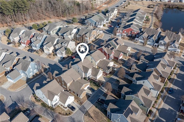 drone / aerial view with a residential view and a water view