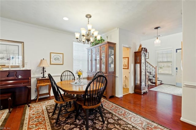 dining room with crown molding, stairway, an inviting chandelier, wood finished floors, and baseboards