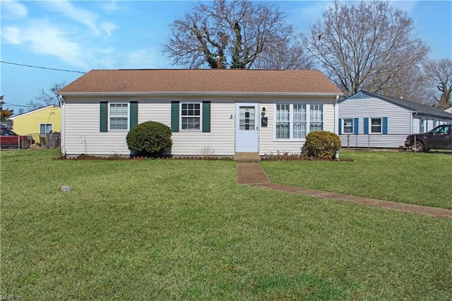 single story home with a shingled roof and a front yard