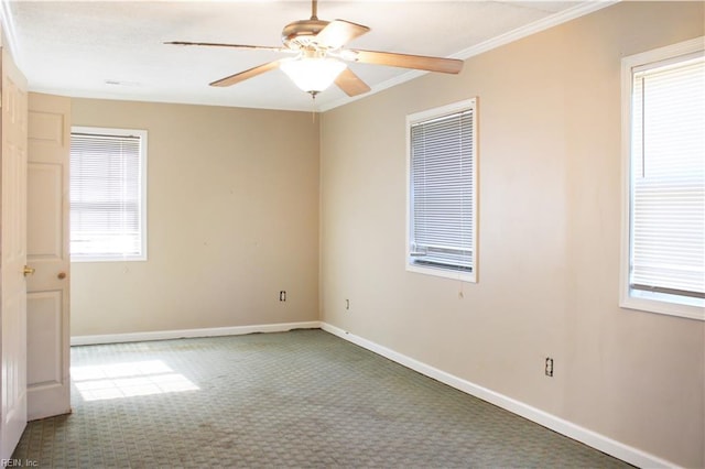 spare room with crown molding, carpet, a ceiling fan, and baseboards