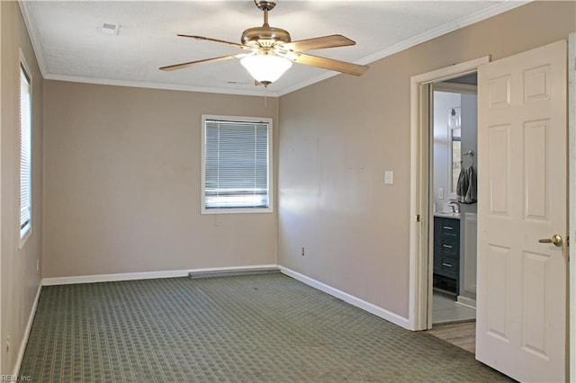 unfurnished bedroom featuring baseboards, carpet, a ceiling fan, and crown molding