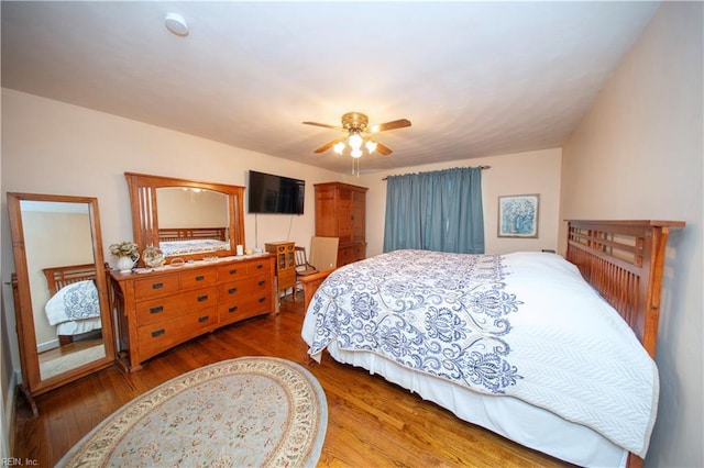 bedroom with ceiling fan and wood finished floors