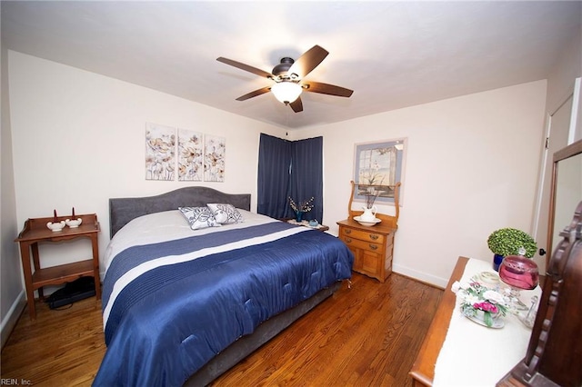 bedroom featuring baseboards, a ceiling fan, and wood finished floors