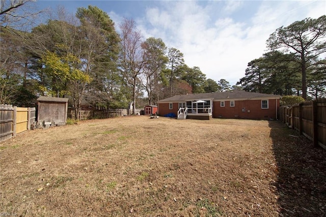 view of yard with an outdoor structure and a fenced backyard