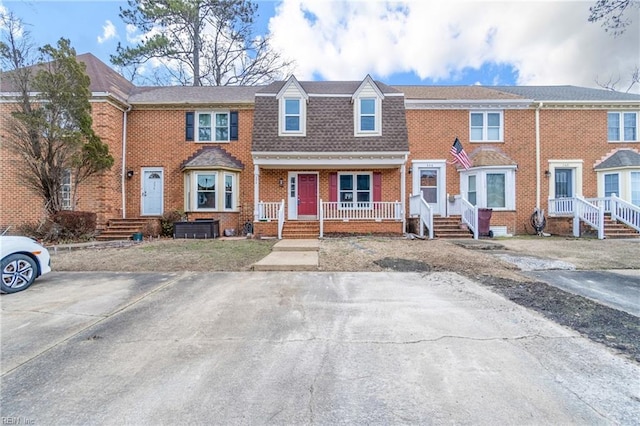 multi unit property with brick siding and roof with shingles