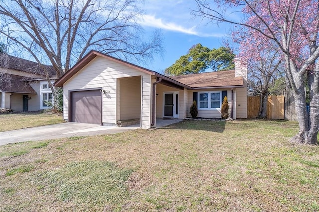 ranch-style house with driveway, an attached garage, fence, and a front yard