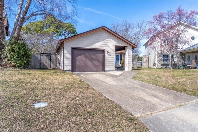 view of front of house featuring concrete driveway, fence, and a front lawn