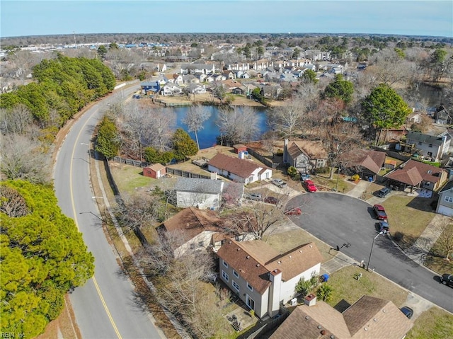 drone / aerial view featuring a water view and a residential view