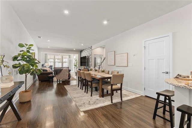 dining area featuring baseboards, stairway, dark wood finished floors, and recessed lighting