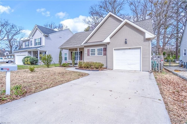 traditional home featuring a garage, concrete driveway, roof with shingles, and fence