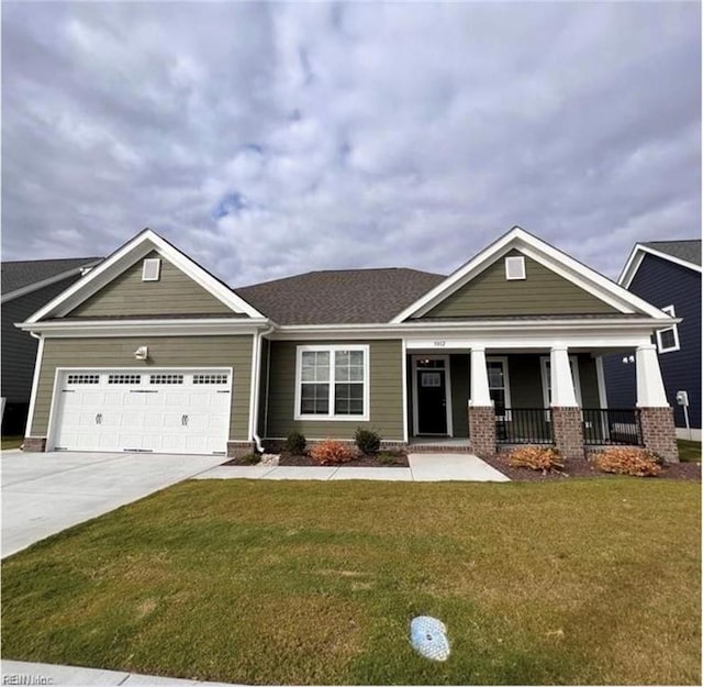 craftsman house featuring an attached garage, driveway, a front lawn, and a porch