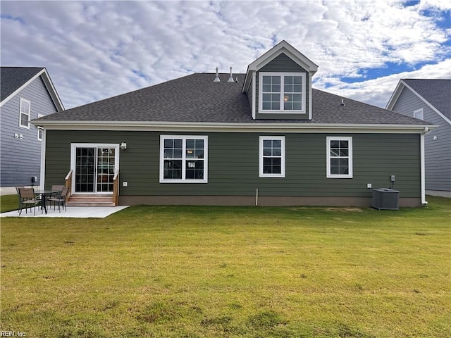 rear view of house featuring a patio, a shingled roof, a lawn, and cooling unit