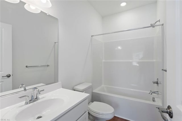 bathroom with bathtub / shower combination, vanity, and toilet