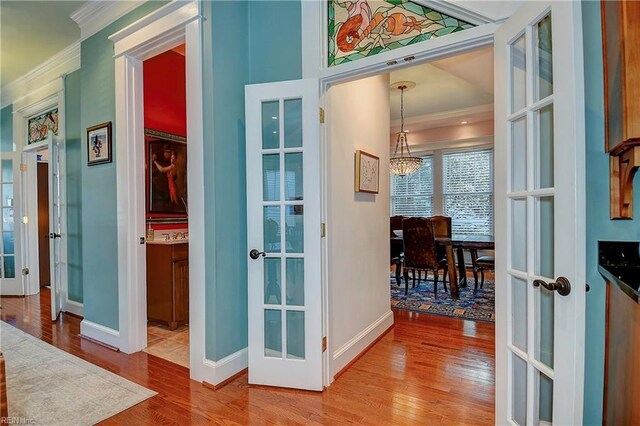 interior space with ornamental molding, french doors, and wood finished floors
