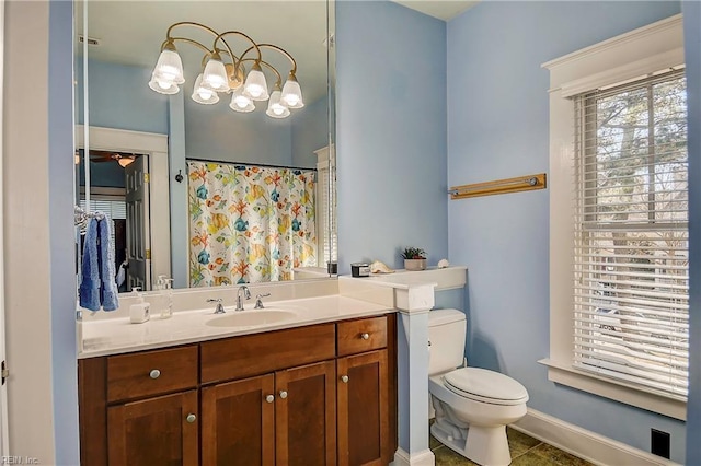bathroom featuring a shower with curtain, baseboards, vanity, and toilet