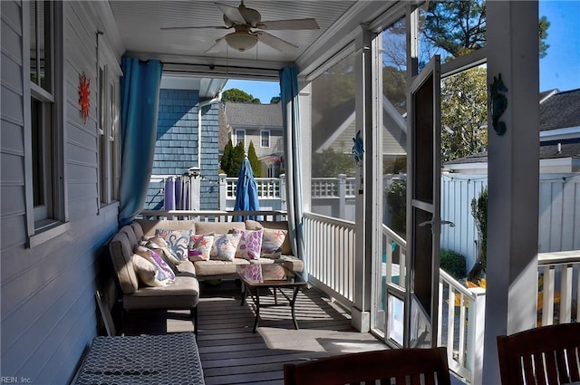 sunroom / solarium with a ceiling fan and a healthy amount of sunlight