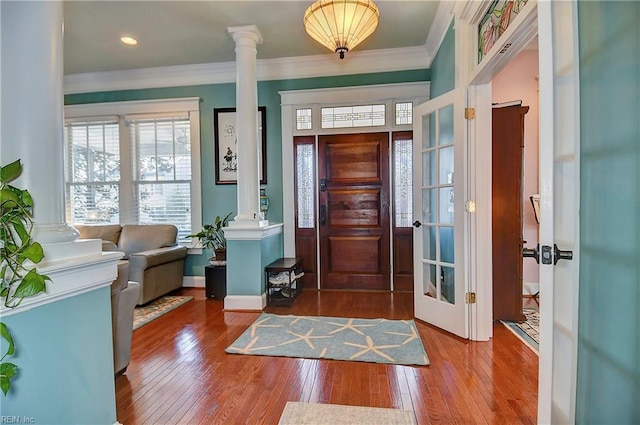 entrance foyer with baseboards, ornamental molding, hardwood / wood-style flooring, and ornate columns