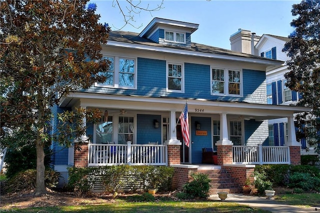 american foursquare style home featuring covered porch