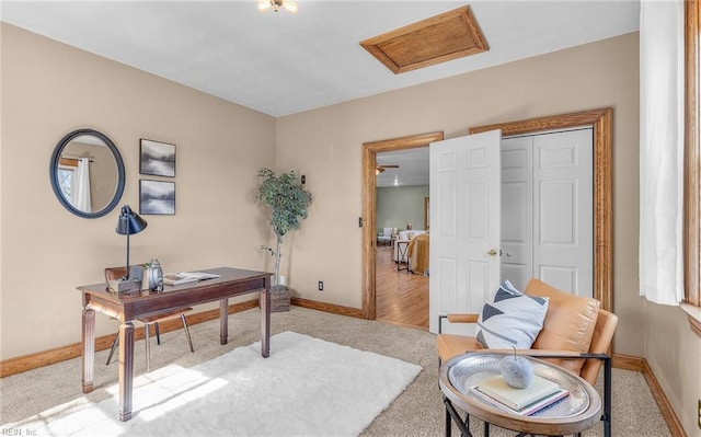 carpeted home office with attic access and baseboards