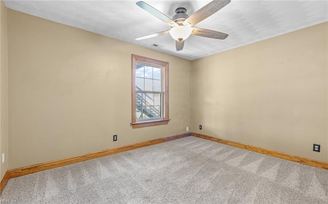 unfurnished room with light carpet, baseboards, visible vents, and ceiling fan