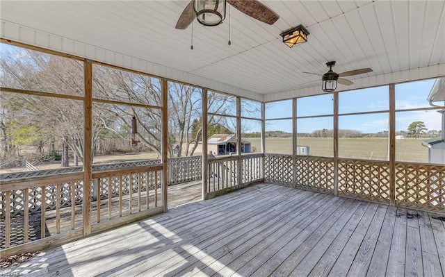 unfurnished sunroom with ceiling fan