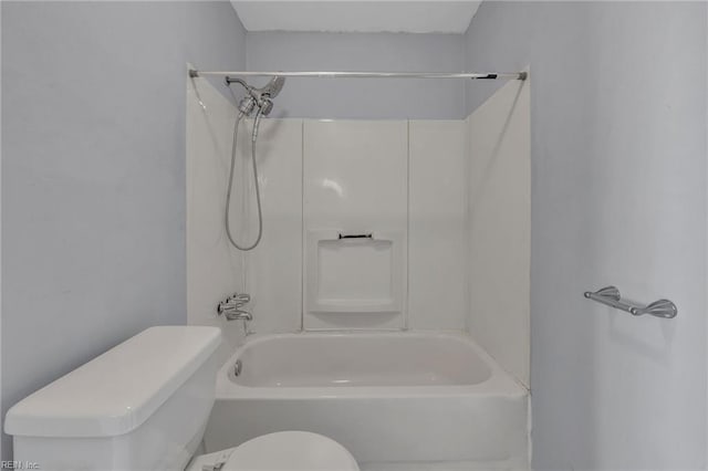 bathroom featuring bathtub / shower combination and toilet