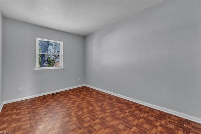 empty room with visible vents and baseboards