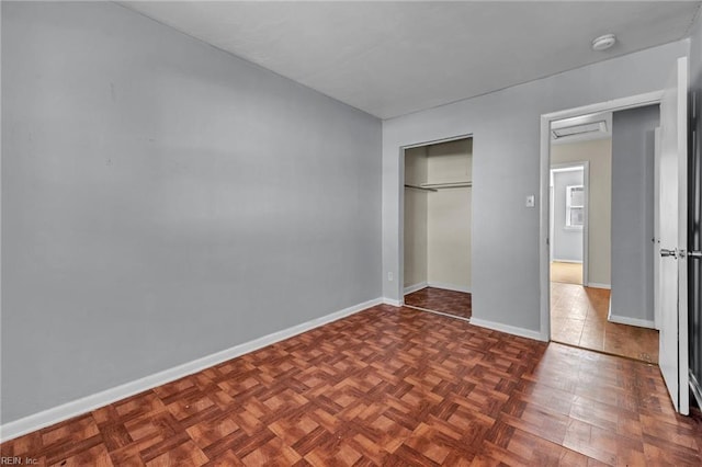 unfurnished bedroom featuring a closet and baseboards