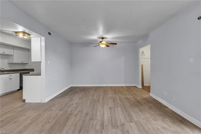 unfurnished living room featuring light wood-style flooring, visible vents, ceiling fan, and baseboards