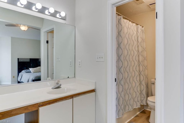 full bath with visible vents, toilet, ensuite bath, curtained shower, and vanity