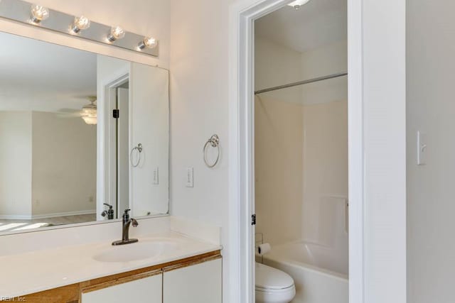 full bathroom featuring toilet, washtub / shower combination, a ceiling fan, and vanity