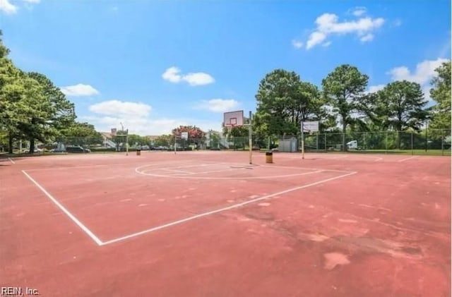 view of basketball court with community basketball court and fence