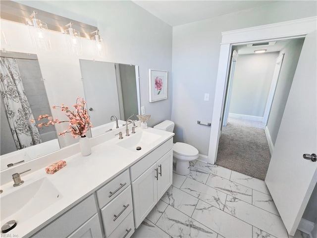 full bathroom with toilet, marble finish floor, baseboards, and a sink