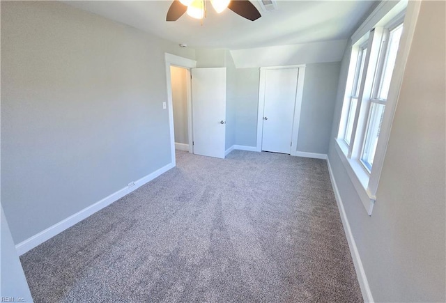 unfurnished bedroom featuring carpet floors, a ceiling fan, and baseboards