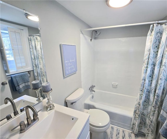 full bath featuring toilet, shower / bathtub combination with curtain, and vanity