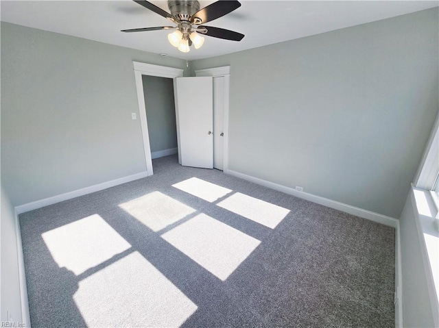 unfurnished bedroom featuring a ceiling fan, carpet flooring, and baseboards