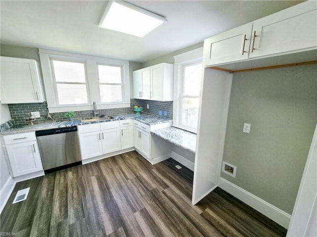 kitchen with light stone counters, stainless steel dishwasher, visible vents, and white cabinetry