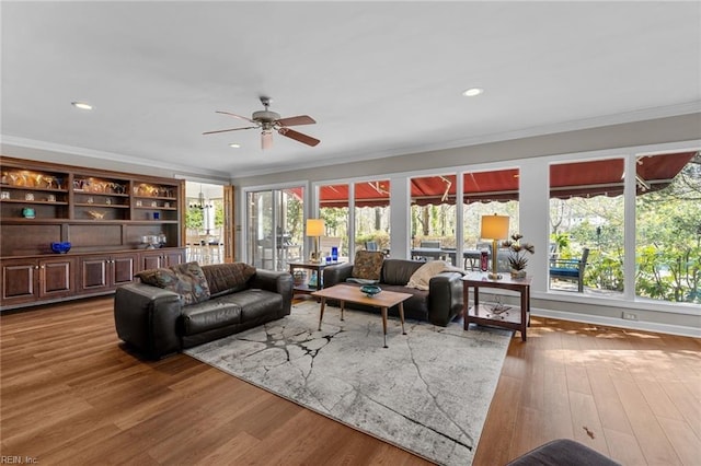 living room featuring ceiling fan, recessed lighting, wood finished floors, and crown molding