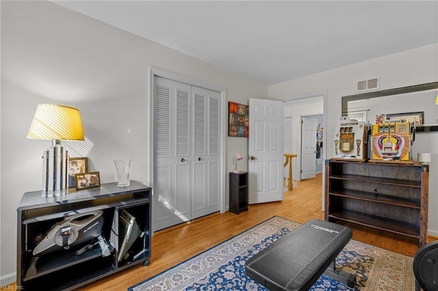 interior space with visible vents, baseboards, and wood finished floors