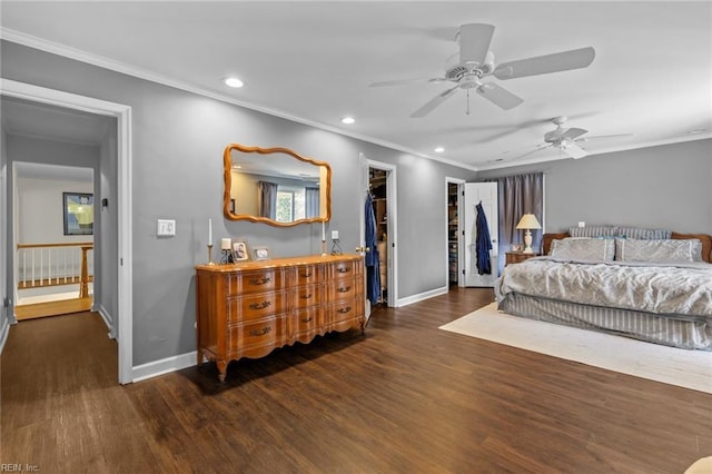 bedroom featuring crown molding, wood finished floors, and baseboards