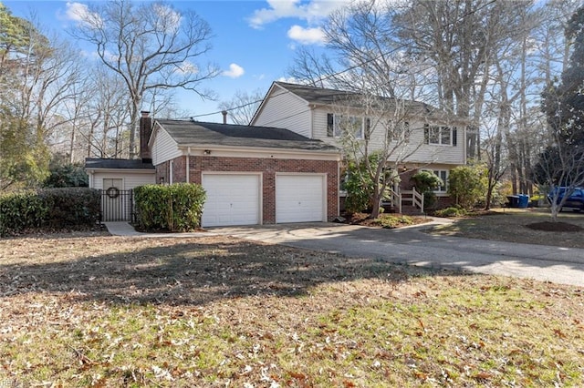 view of front of property featuring concrete driveway, brick siding, a chimney, and an attached garage