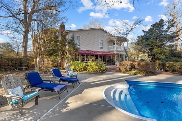 view of swimming pool with a patio, fence, and a fenced in pool