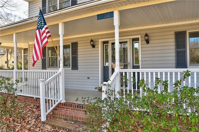 view of exterior entry with a porch