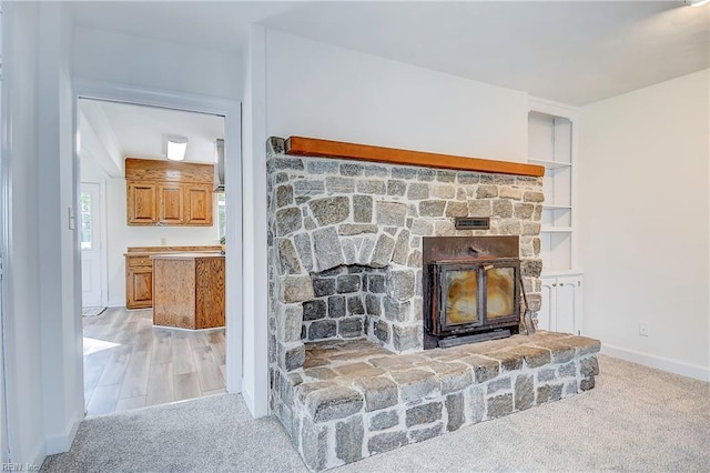 details with carpet, a glass covered fireplace, and baseboards