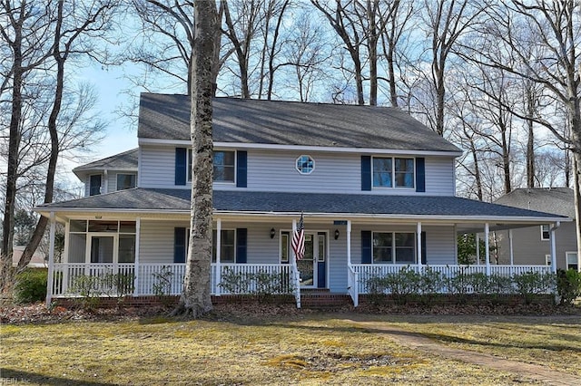 farmhouse-style home featuring a porch and a front lawn