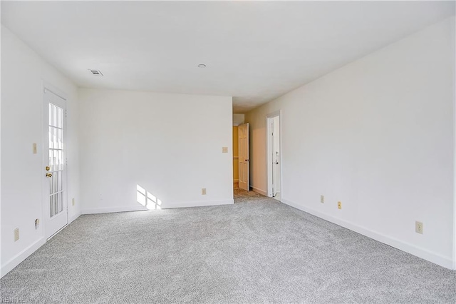 unfurnished room with baseboards and carpet flooring