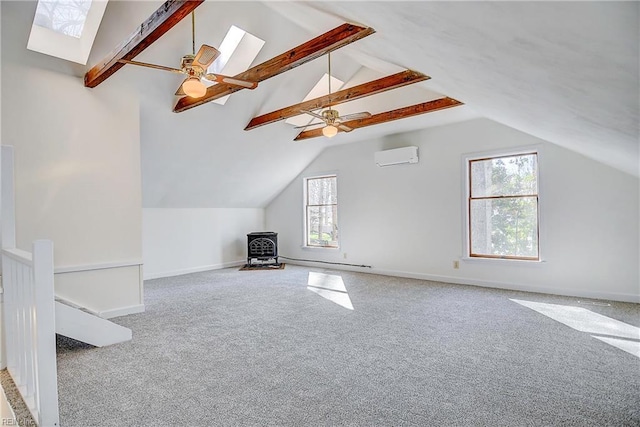 bonus room featuring carpet floors, an AC wall unit, baseboards, and lofted ceiling with skylight