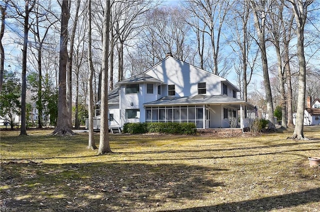 view of front of home featuring a front lawn and a sunroom