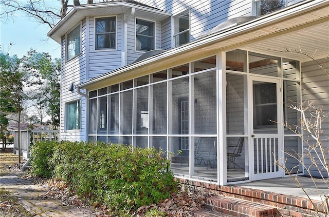 view of side of property featuring a sunroom